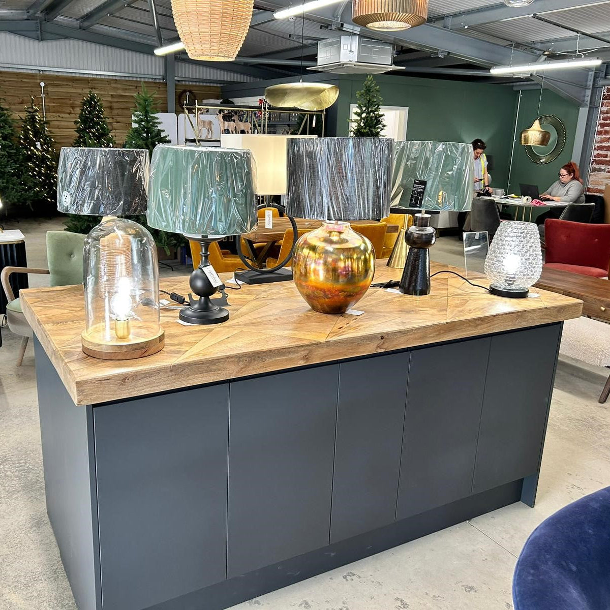 Modern interior design showroom with furniture and decorative items.